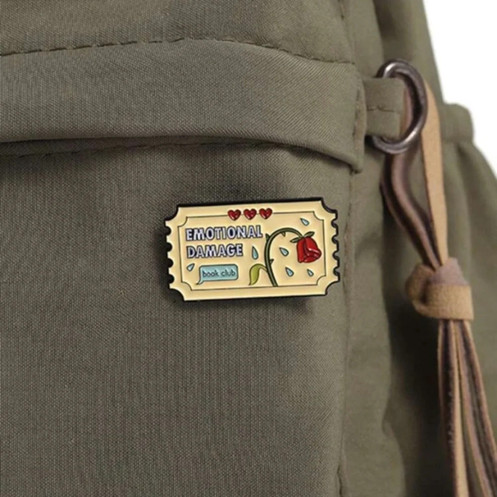 Yellow with red rose raffle ticket Emotional Damage Book Club enamel pin bag hat